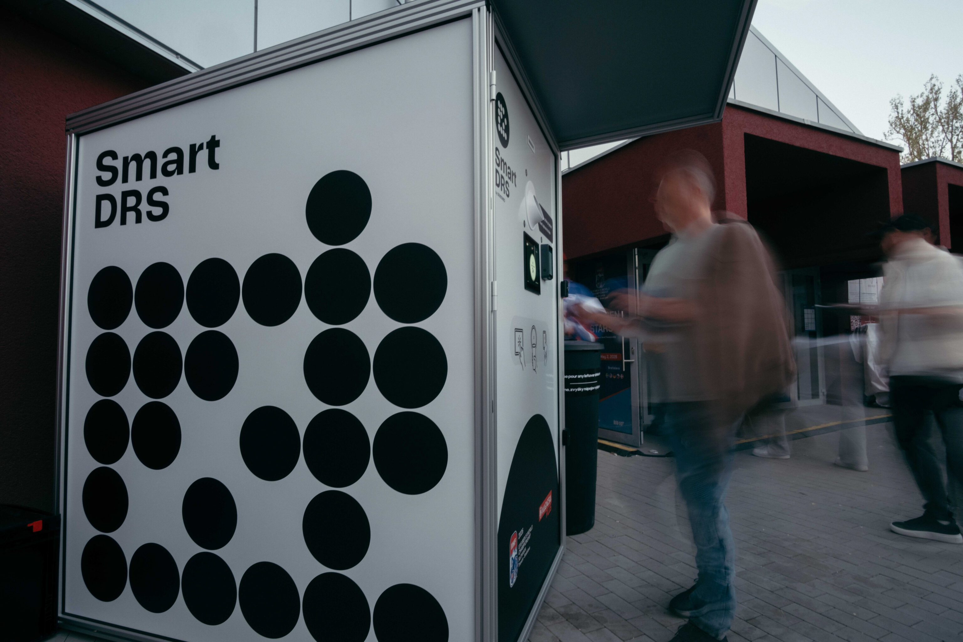 Smart DRS return unit beside visitors at a public venue.
