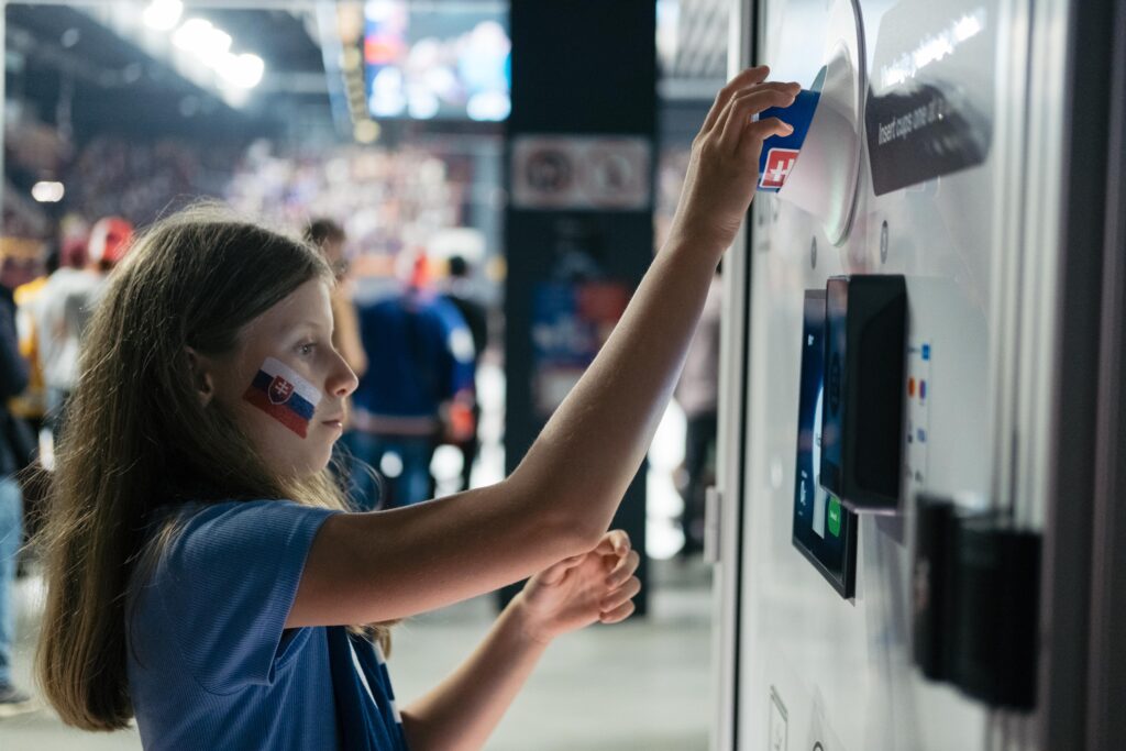 User experience with the automated reusable cup return stations at the 2026 IIHF U18 Championship. 
