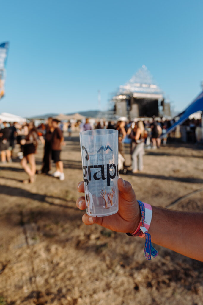 Reusable Grape Festival cup held in front of the festival grounds