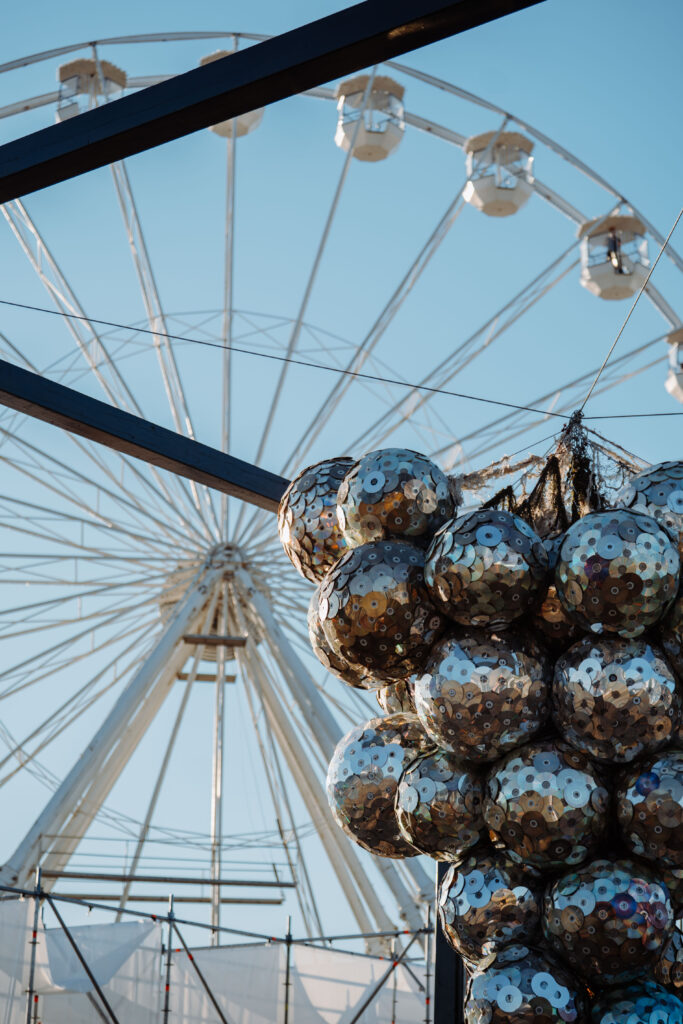 Ferris wheel and reflective art installation at Grape Festival 2026