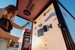 Visitor using reusable packaging identification technology at a Smart DRS return station