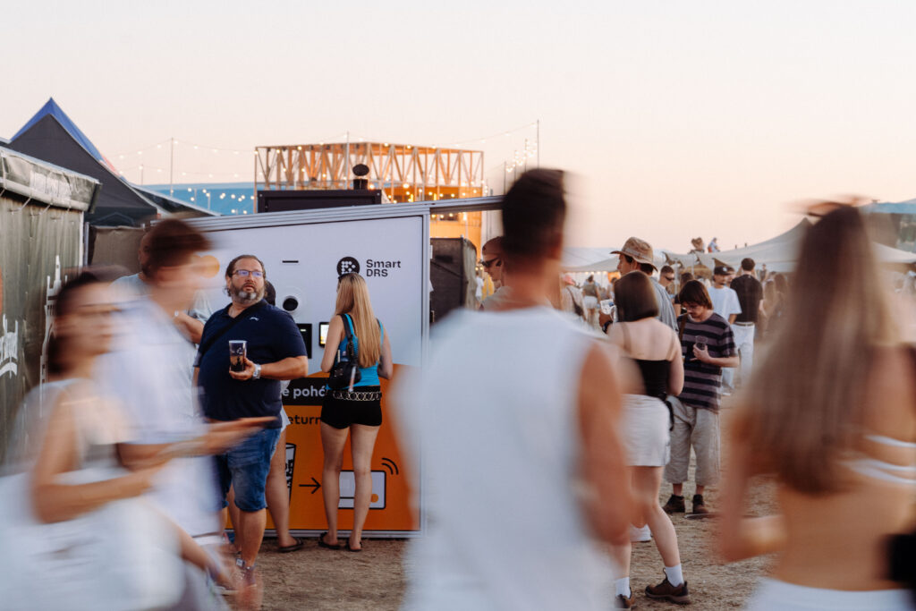 Festival visitors using a Smart DRS automated reusable cup return point at an outdoor event.