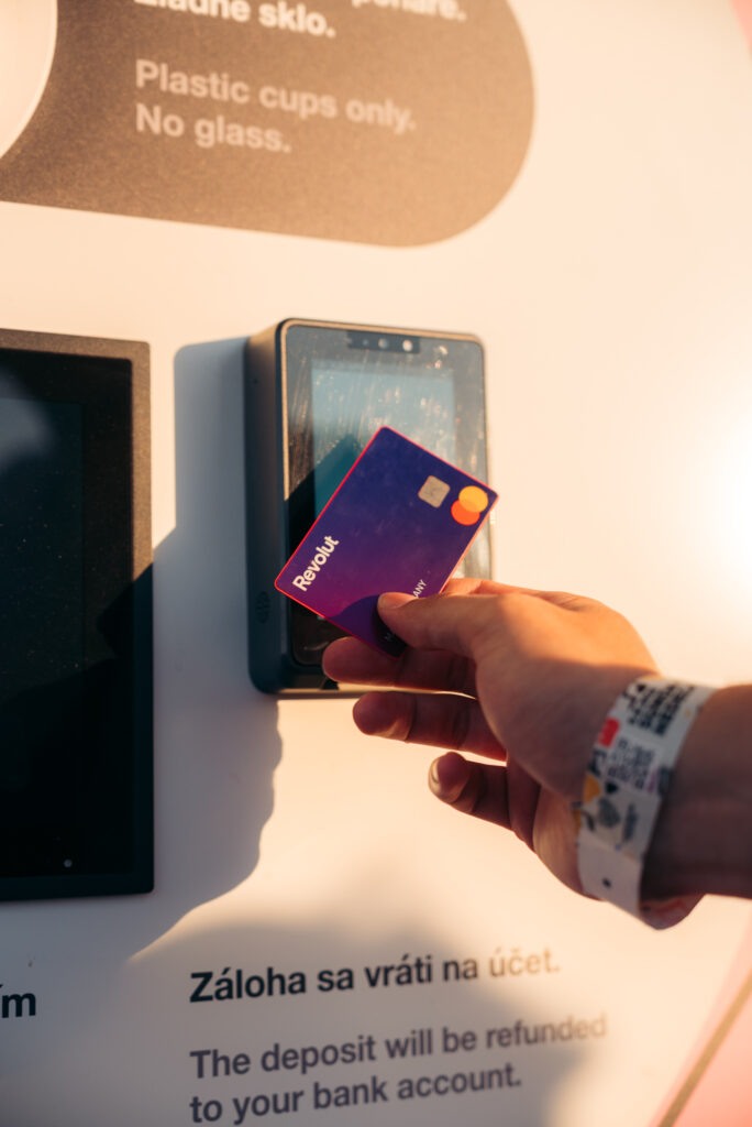 Festival visitor tapping a payment card at a Smart DRS return station to receive a reusable cup deposit refund at LOVESTREAM Festival 2026.