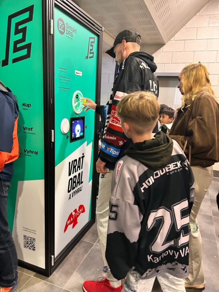 Návštěvník vrací PET lahev do automatu Smart DRS na stadionu