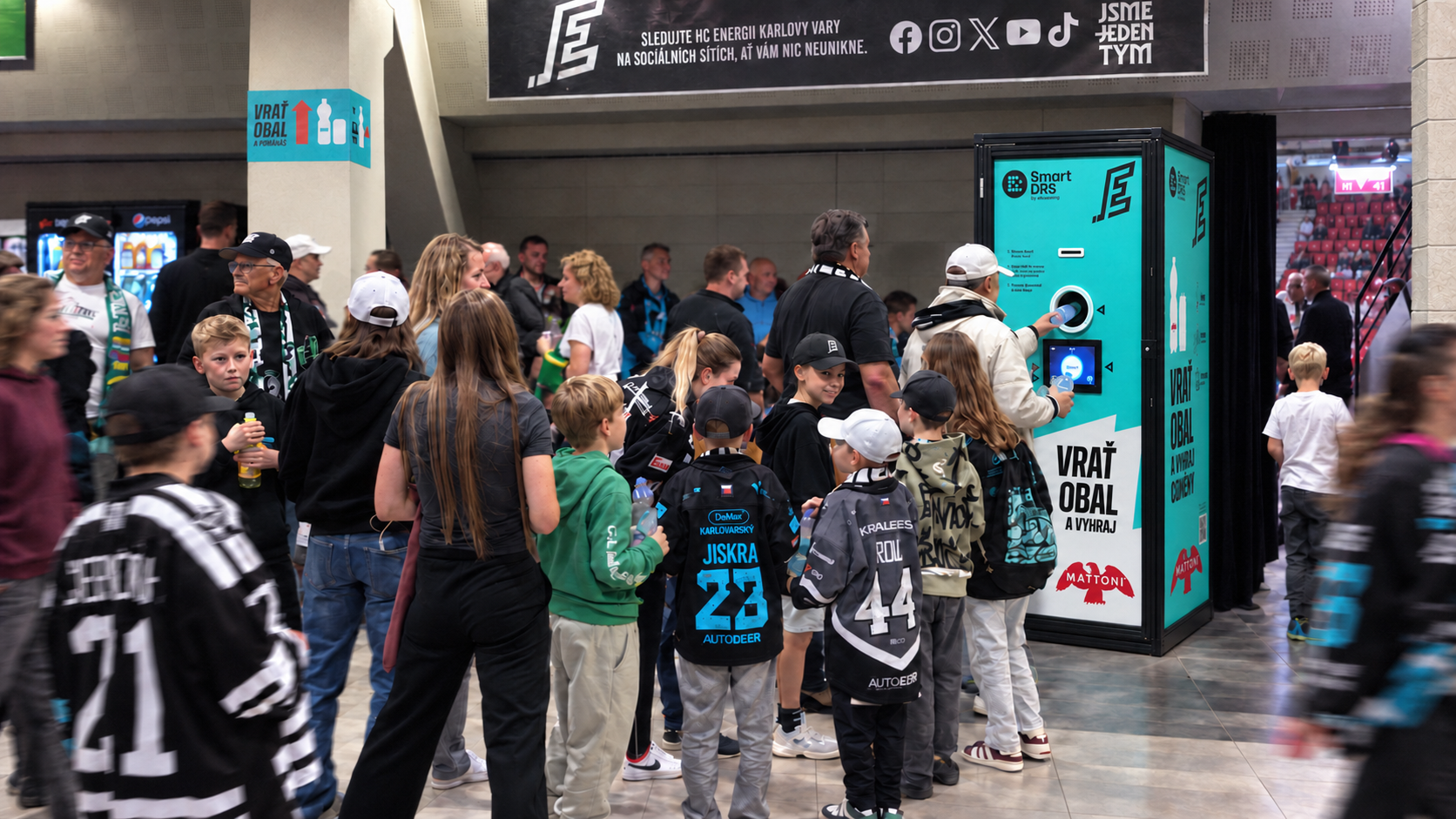 Visitors returning single-use beverage containers at a Smart DRS collection point in a Czech ice hockey arena